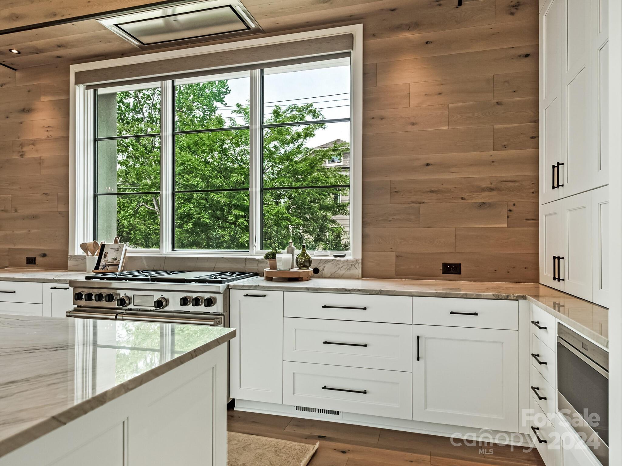 2717 Westfield Road Charlotte, NC 28209 - Photo 11 of 32 a kitchen with stainless steel appliances white cabinets and a window