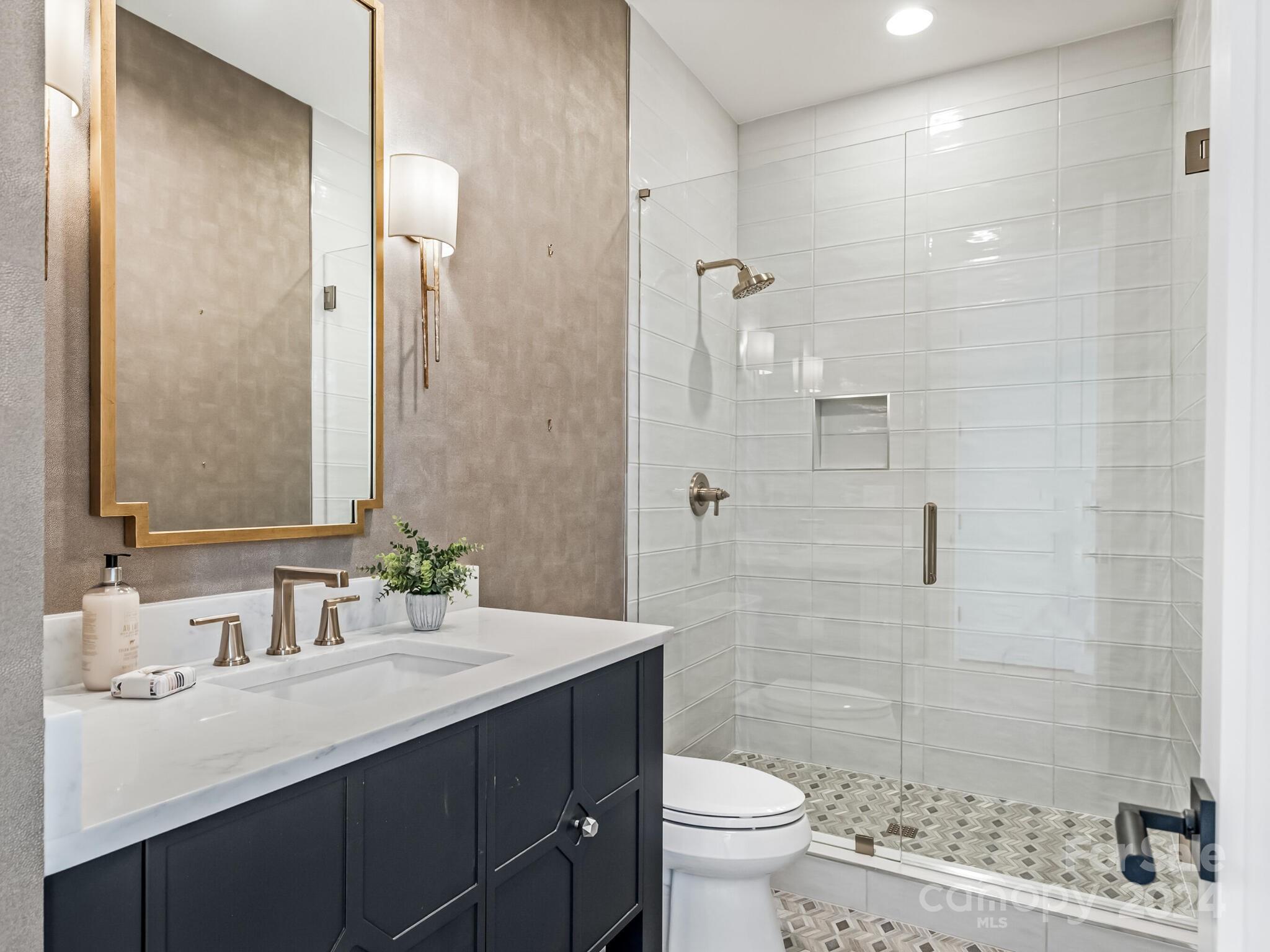 2717 Westfield Road Charlotte, NC 28209 - Photo 13 of 32 a bathroom with a sink a toilet and shower