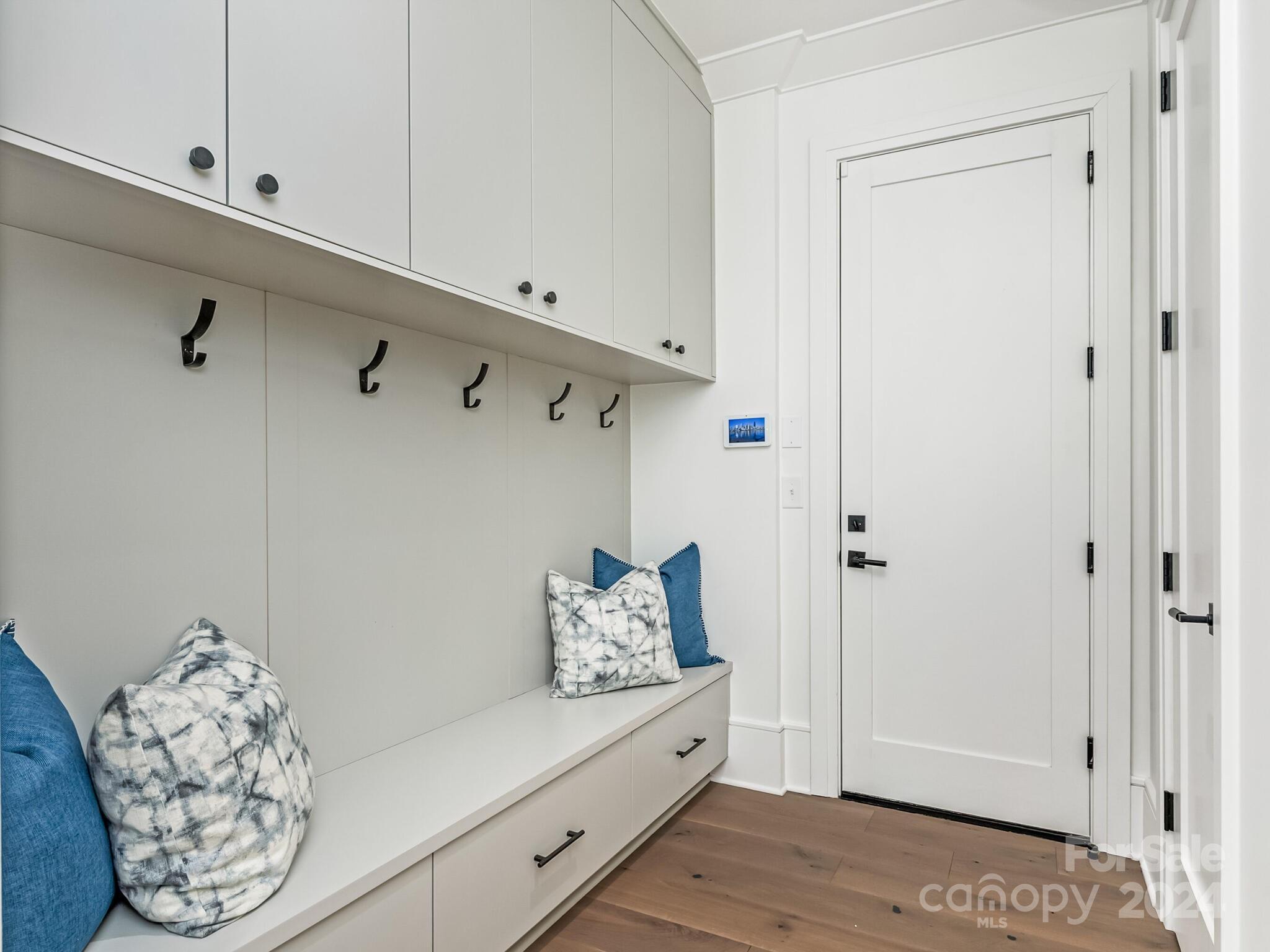 2717 Westfield Road Charlotte, NC 28209 - Photo 14 of 32 a hallway with white doors wooden floor and stairs