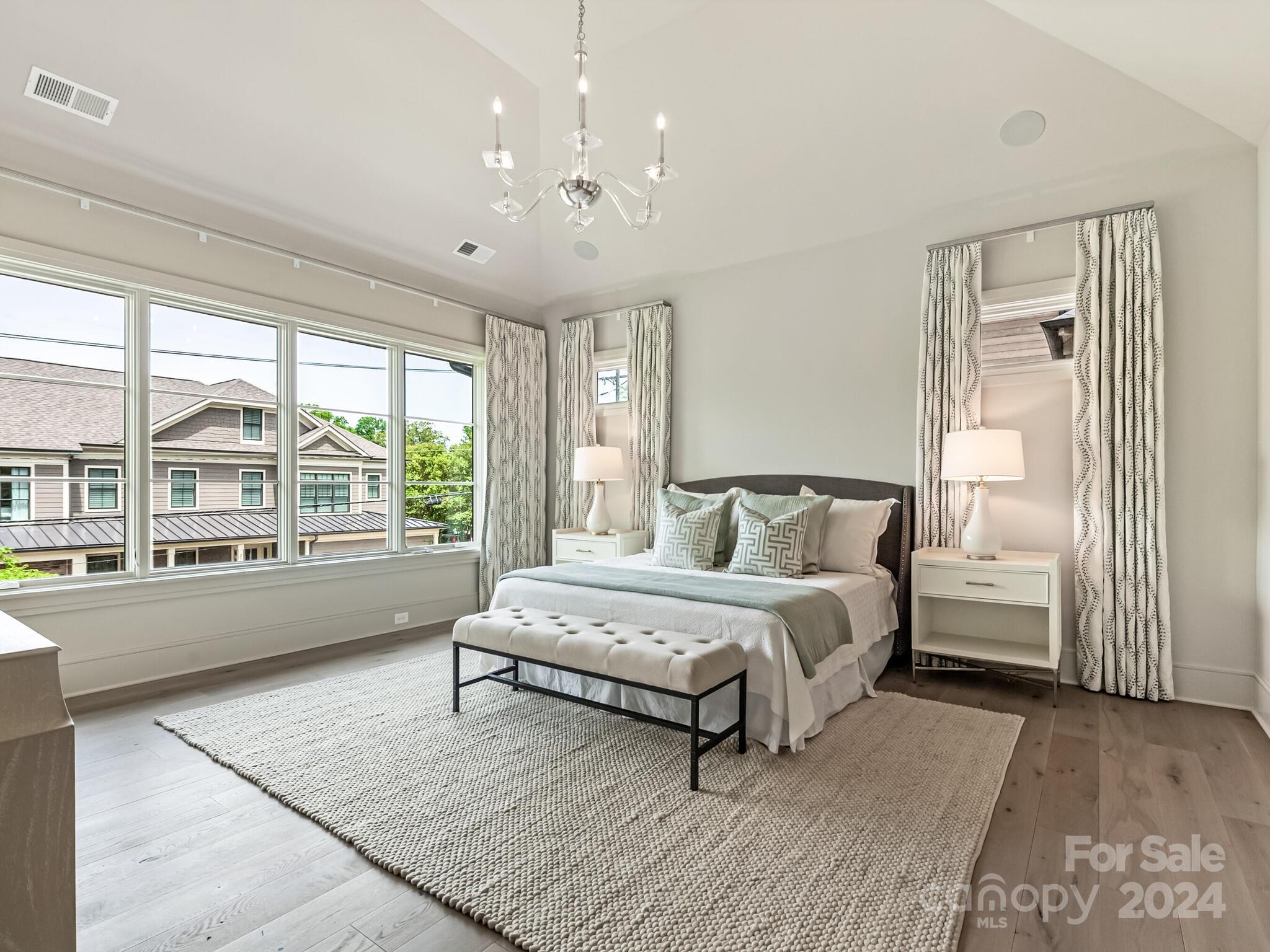 2717 Westfield Road Charlotte, NC 28209 - Photo 16 of 32 a spacious bedroom with a large bed and a chandelier