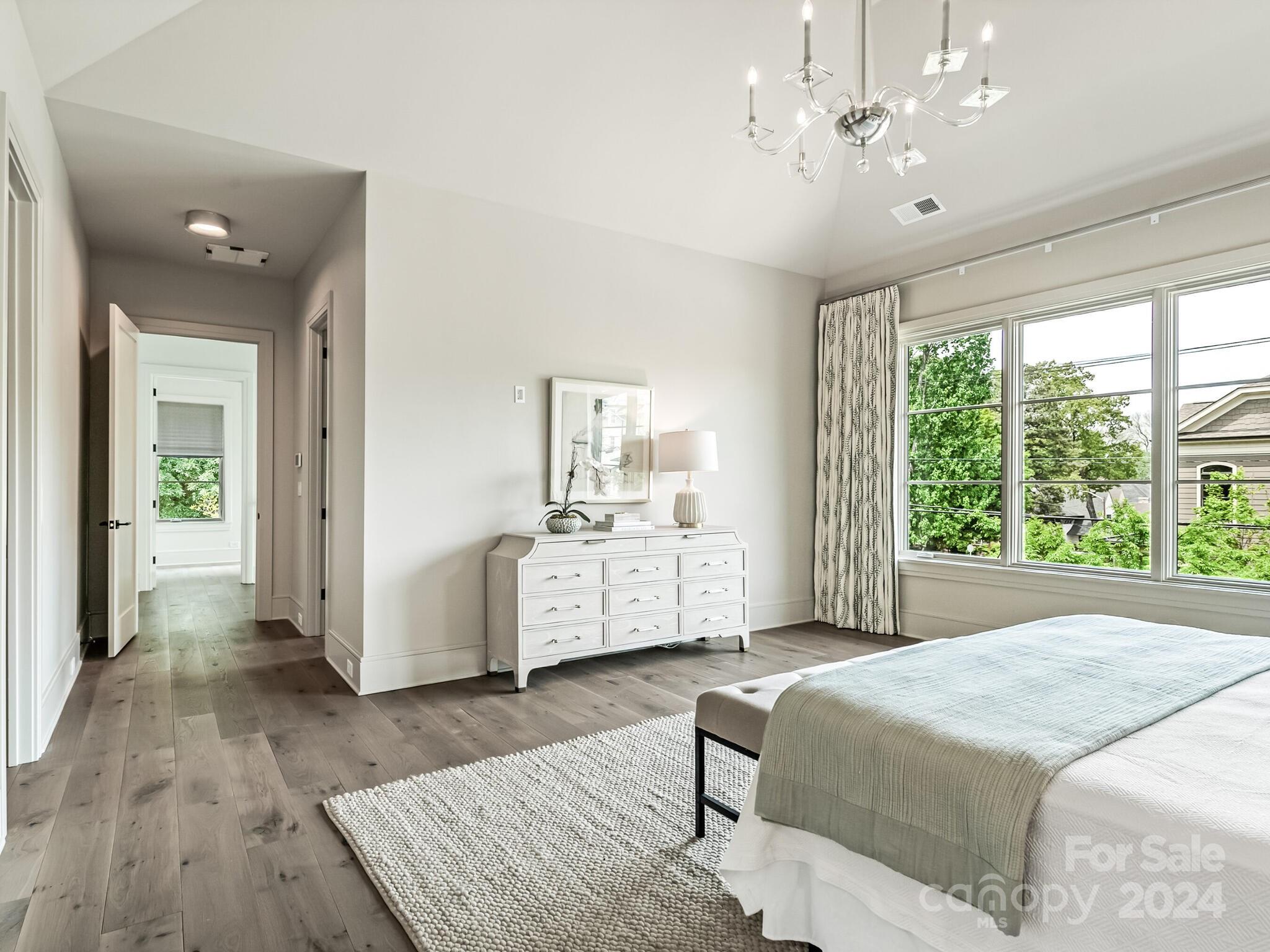 2717 Westfield Road Charlotte, NC 28209 - Photo 17 of 32 a spacious bedroom with a bed and a chandelier