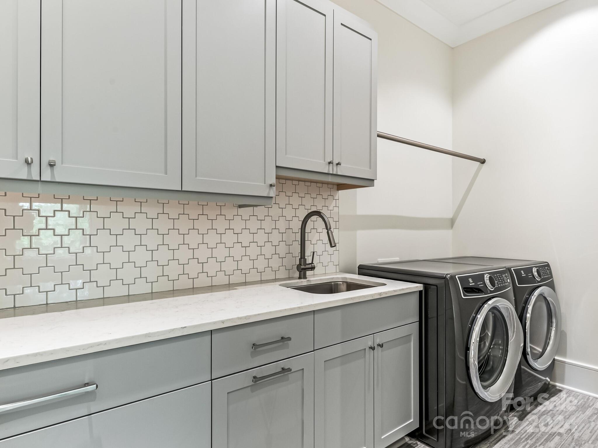 2717 Westfield Road Charlotte, NC 28209 - Photo 22 of 32 a view of a storage and utility room with sink washer and dryer