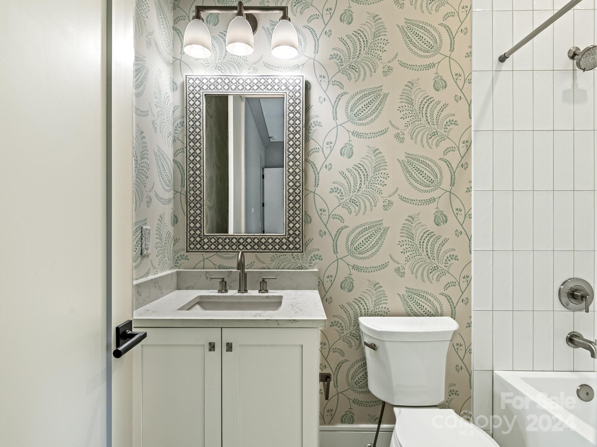 2717 Westfield Road Charlotte, NC 28209 - Photo 24 of 32 a bathroom with a sink a toilet and shower