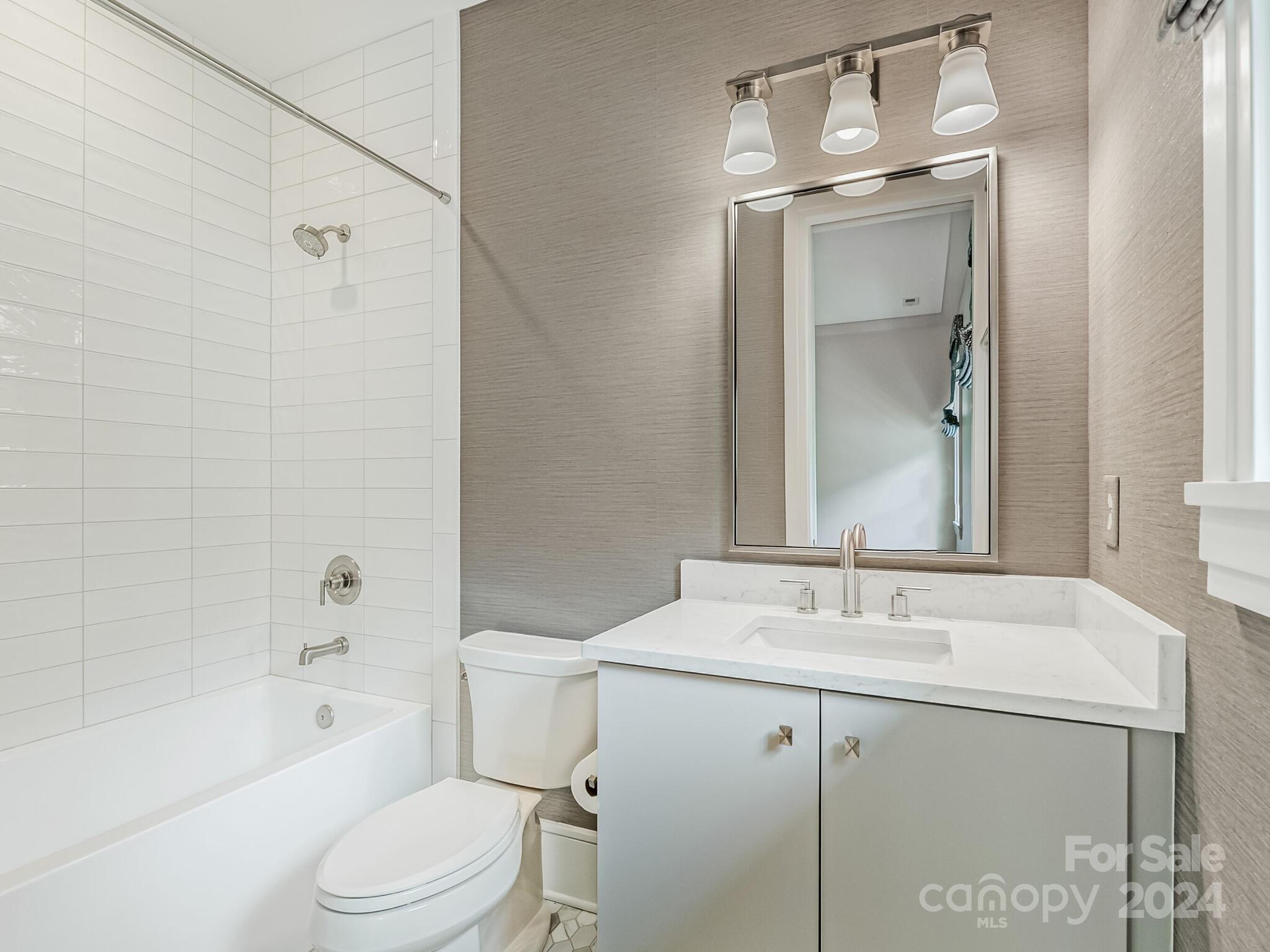 2717 Westfield Road Charlotte, NC 28209 - Photo 28 of 32 a bathroom with a bathtub shower sink vanity mirror and toilet