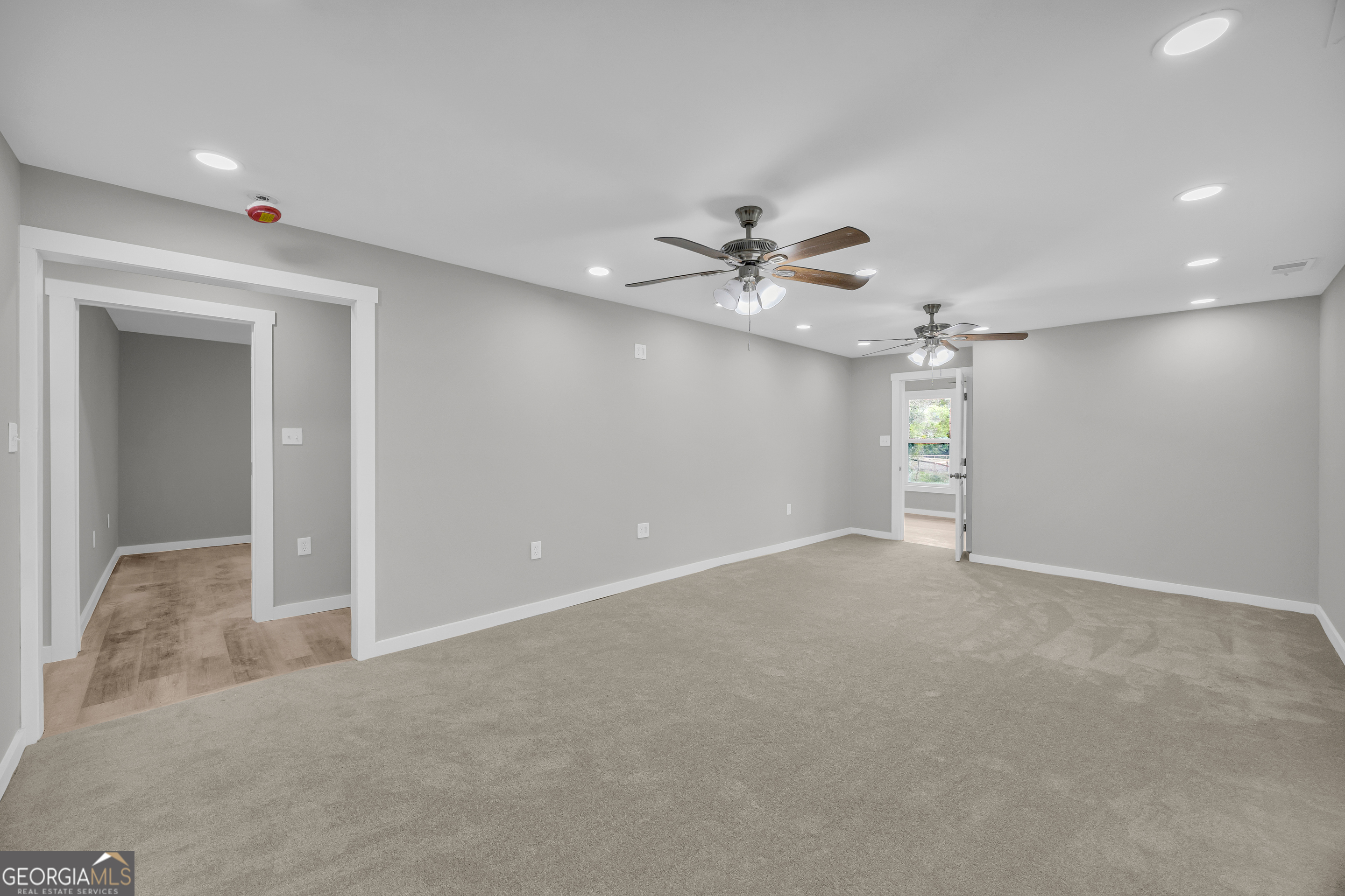 8606 Holly Springs Road Maysville, GA 30558 - Photo 48 of 74 a view of an empty room with a chandelier fan