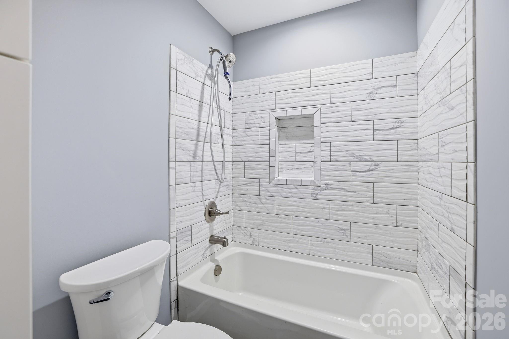 1108 Willoughby Road Monroe, NC 28110 - Photo 7 of 48 a bathroom with a toilet and bathtub