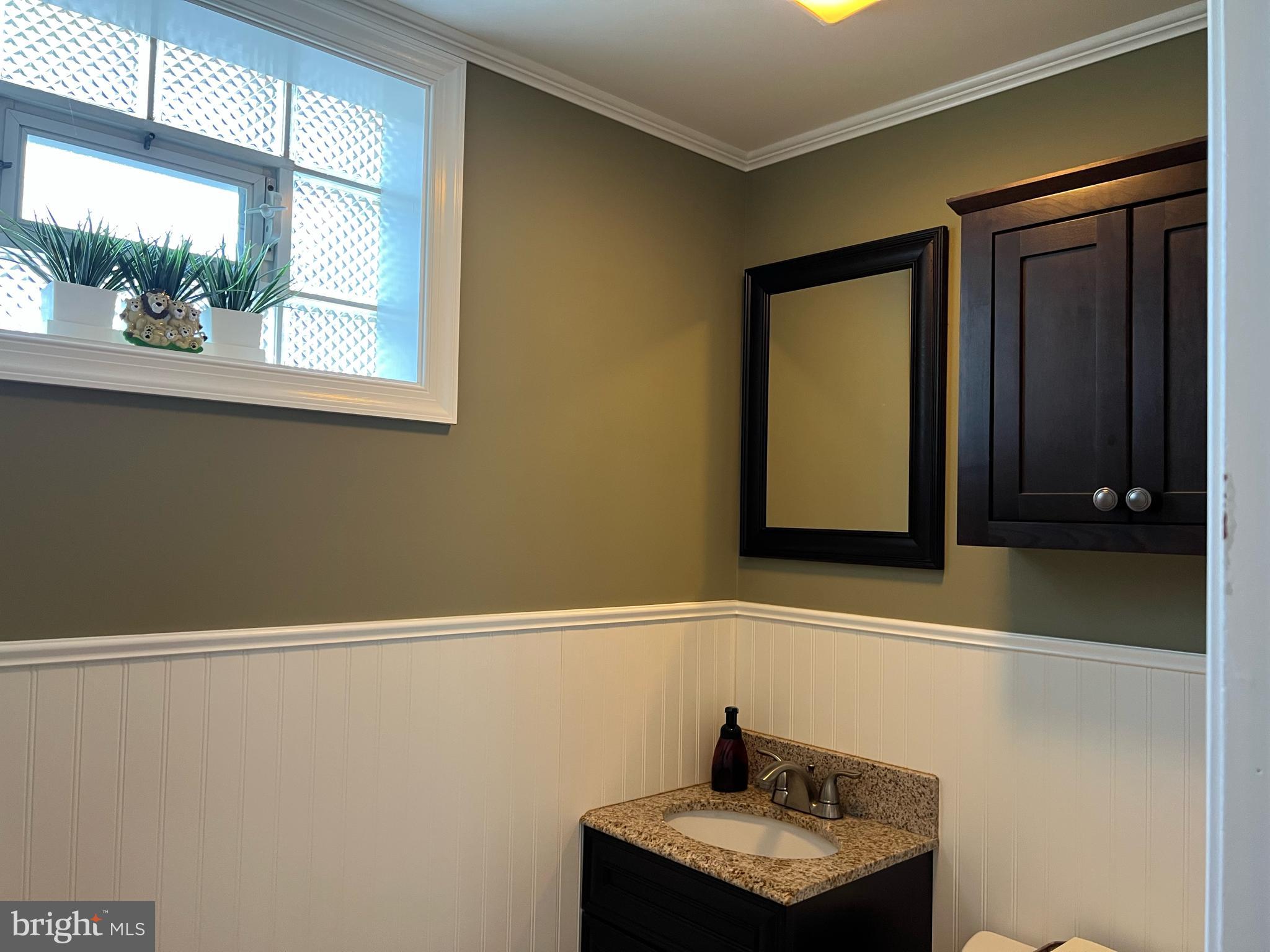 3814 Inwood Lane Philadelphia, PA 19154 - Photo 25 of 37 a bathroom with a sink a mirror and window