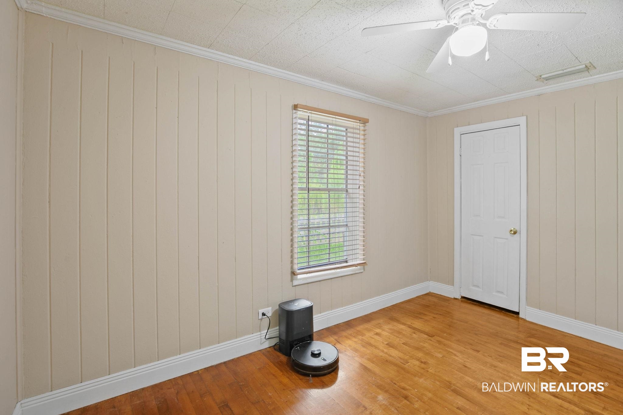 23240 County Road 47 Perdido, AL 36562 - Photo 22 of 29 Empty room featuring ornamental molding, wood finished floors, wood walls, and ceiling fan