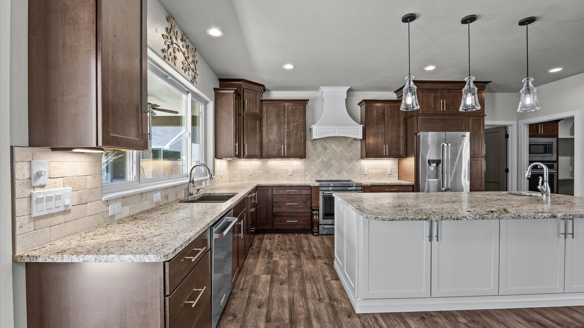 2041 J J 1/2 Road Fruita, CO 81521 - Photo 9 of 42 a kitchen with granite countertop a sink a counter top space appliances and cabinets