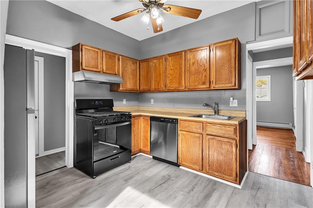 825 Walnut Street Rochester, PA 15074 - Photo 11 of 24 a kitchen with stainless steel appliances granite countertop a stove a sink and a refrigerator