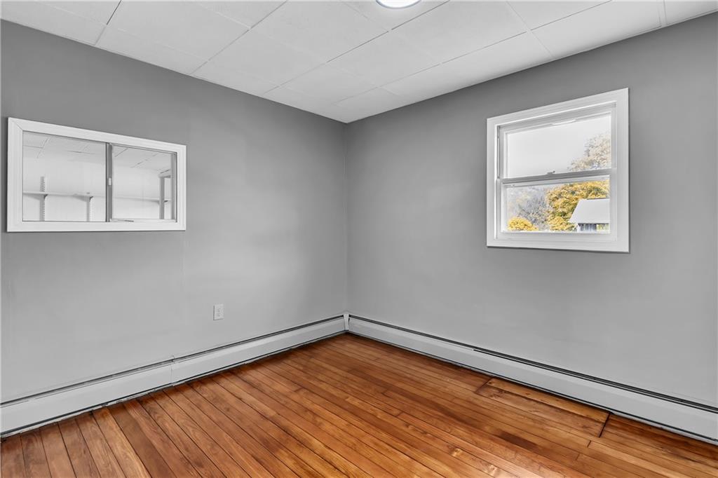 825 Walnut Street Rochester, PA 15074 - Photo 12 of 24 a view of an empty room with window and wooden floor