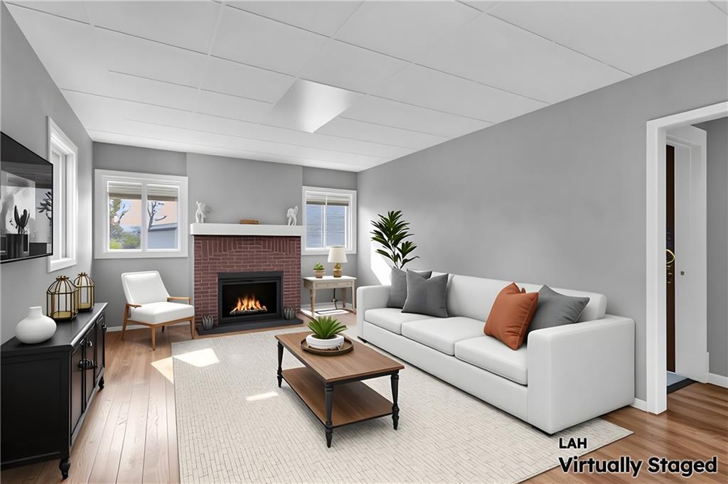 825 Walnut Street Rochester, PA 15074 - Photo 4 of 24 a living room with furniture and a fireplace