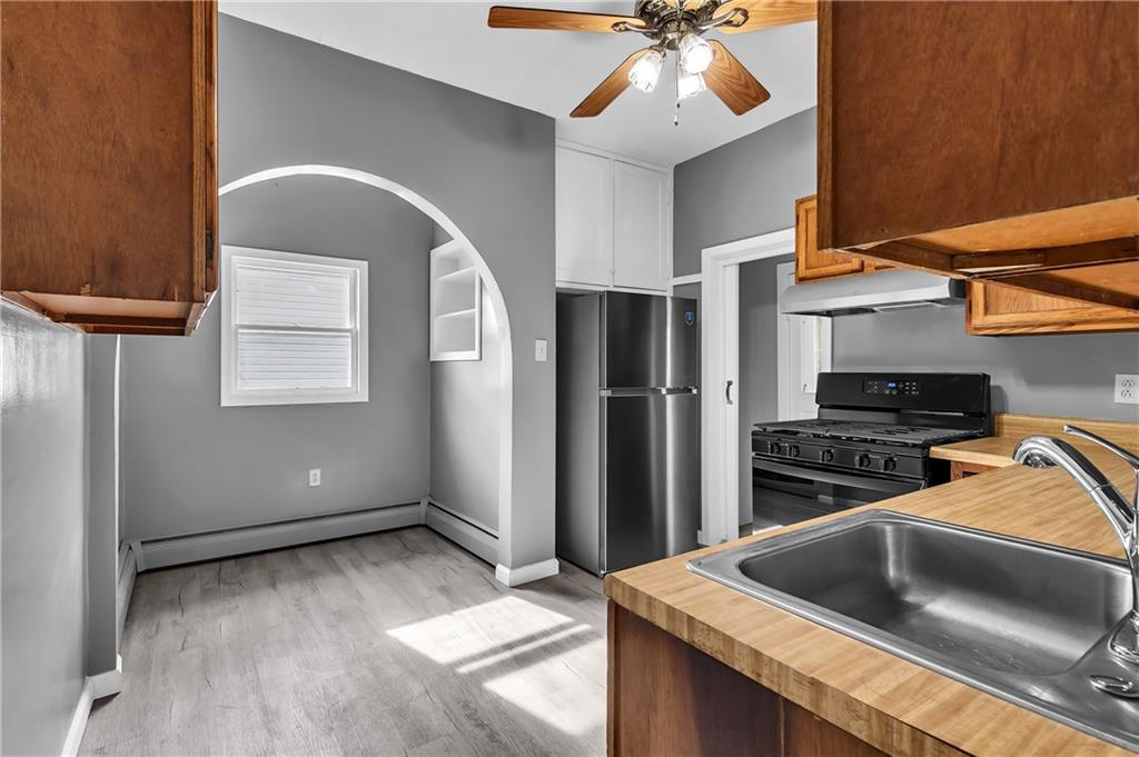 825 Walnut Street Rochester, PA 15074 - Photo 7 of 24 a kitchen with a stove and a refrigerator