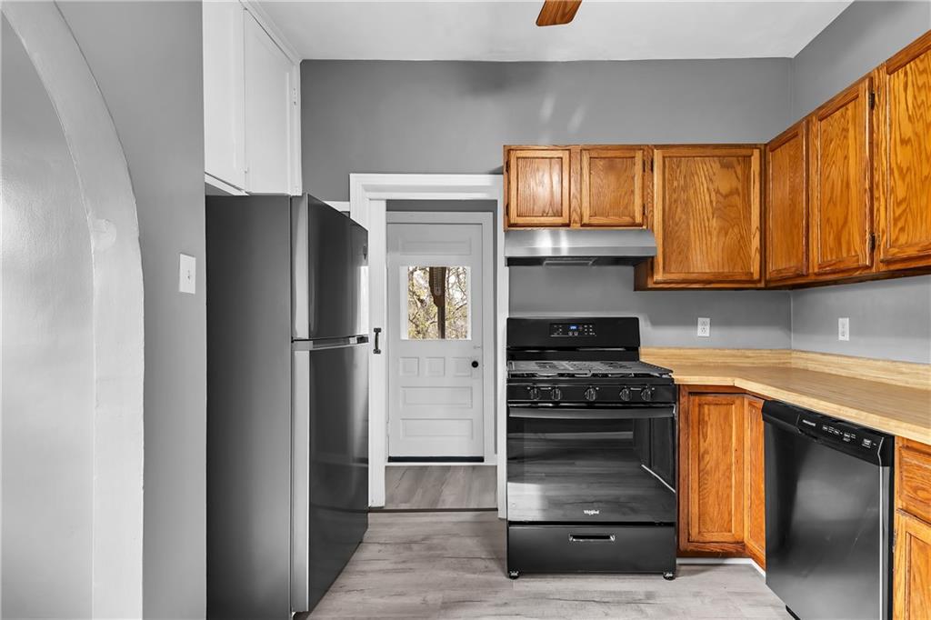 825 Walnut Street Rochester, PA 15074 - Photo 10 of 24 a kitchen with stainless steel appliances granite countertop a refrigerator and a stove