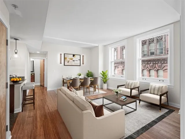 a view of a big room with wooden floor and windows