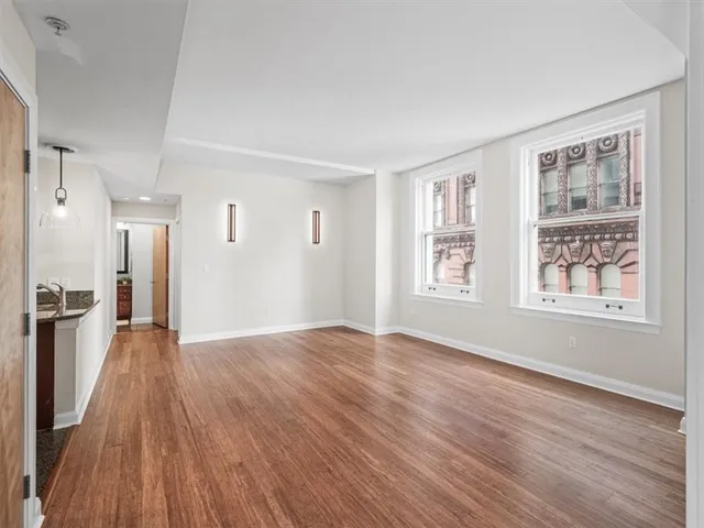 a view of wooden floor and windows in a room