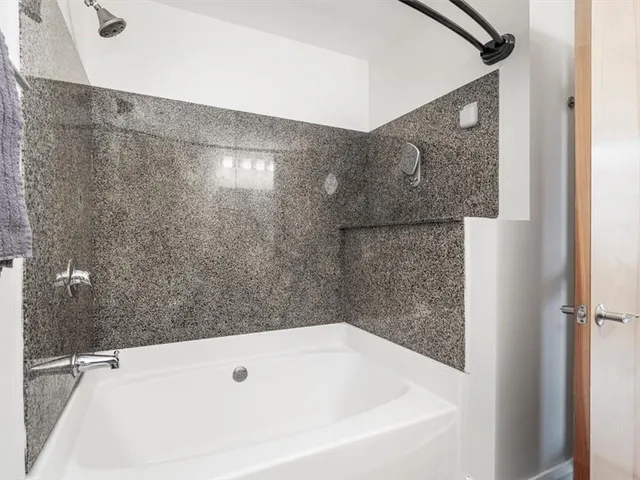 a bedroom with a large bed and a flat screen tv