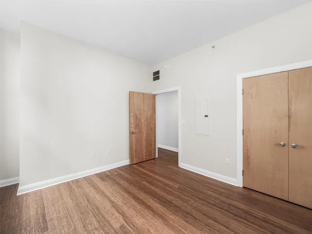 a bathroom with a granite countertop sink toilet mirror and shower