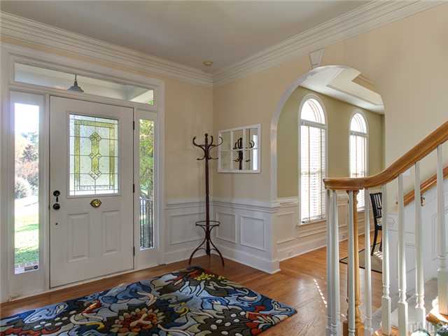 408 Reedham Way Raleigh, NC 27615 - Photo 2 of 25 Foyer has wainscoting, hardwood floors, and room for furniture pieces.