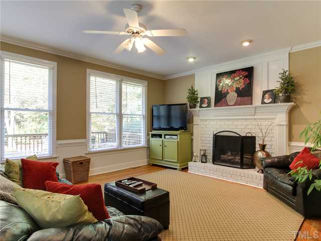408 Reedham Way Raleigh, NC 27615 - Photo 5 of 25 Family room has fireplace with raised hearth, brick surround, and floor to ceiling mantle. Nice views of private backyard and open to kitchen.