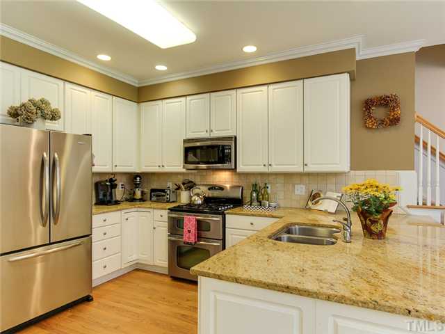 408 Reedham Way Raleigh, NC 27615 - Photo 10 of 25 Kitchen has plenty of cabinets and seating for 3 at the counter.