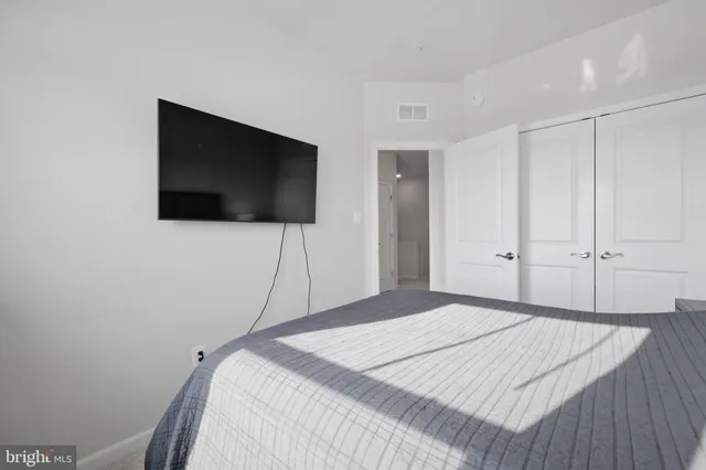 a bedroom with a bed and a flat screen tv