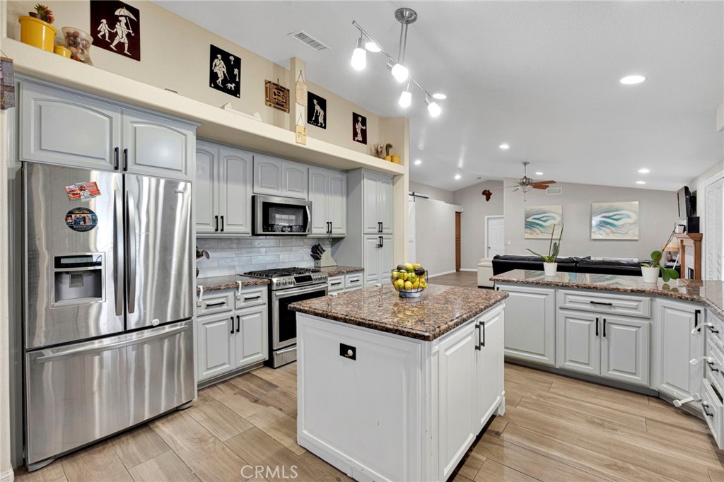 17777 Brazier Drive Riverside, CA 92508 - Photo 15 of 58 a kitchen with stainless steel appliances granite countertop a refrigerator a stove and a sink