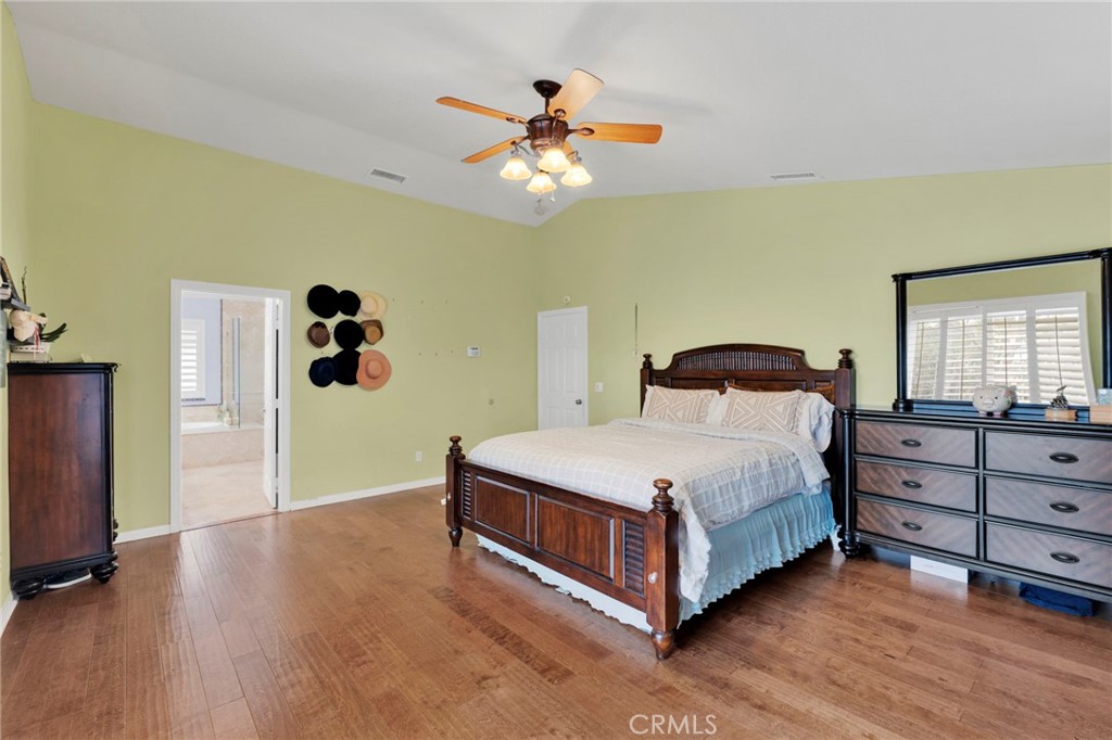 17777 Brazier Drive Riverside, CA 92508 - Photo 20 of 58 a bedroom with a bed and a chandelier