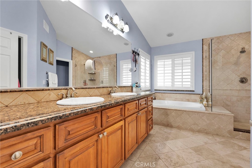 17777 Brazier Drive Riverside, CA 92508 - Photo 21 of 58 a spacious bathroom with a granite countertop double vanity sink a mirror and a bathtub