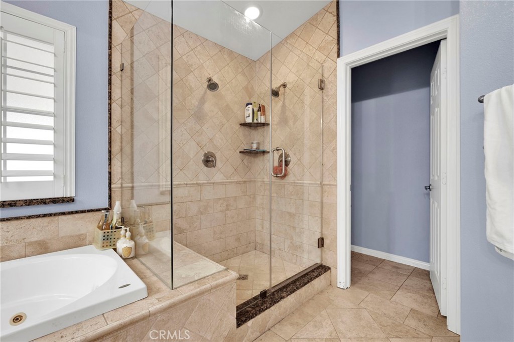 17777 Brazier Drive Riverside, CA 92508 - Photo 23 of 58 a bathroom with a tub and a shower