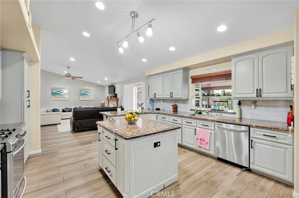 17777 Brazier Drive Riverside, CA 92508 - Photo 3 of 58 a kitchen with counter top space a sink cabinets and wooden floor
