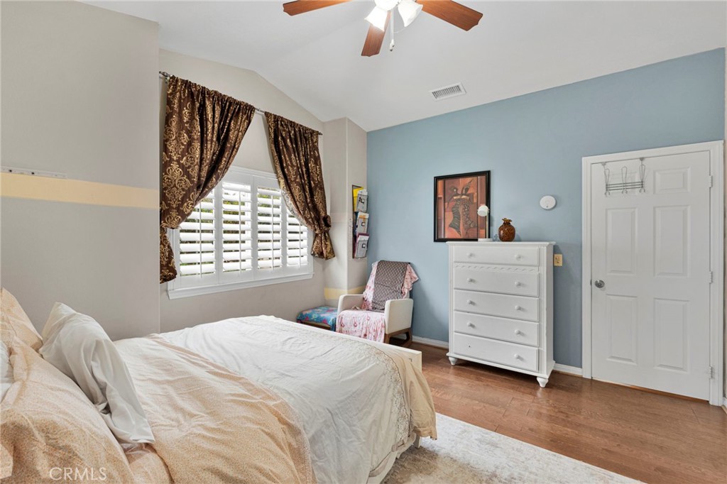 17777 Brazier Drive Riverside, CA 92508 - Photo 32 of 58 a bedroom with a bed and a chandelier