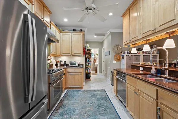 a kitchen with stainless steel appliances granite countertop a stove a sink and a refrigerator