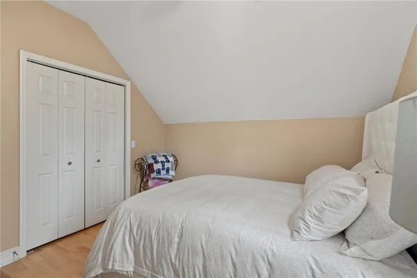 an aerial view of a house with swimming pool and trees