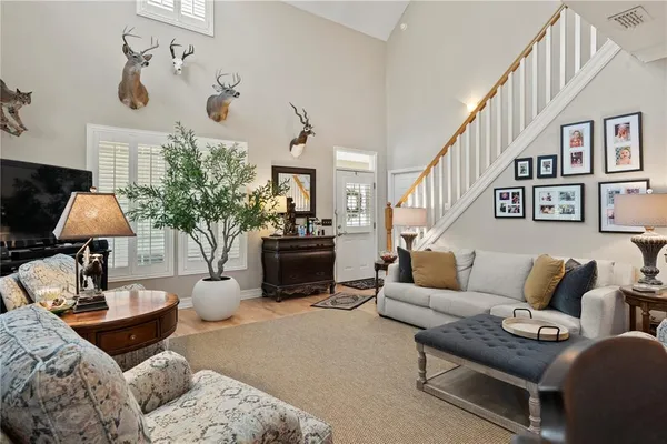 a living room with furniture a fireplace and a chandelier