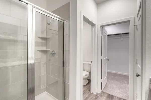a bathroom with a shower and a glass door