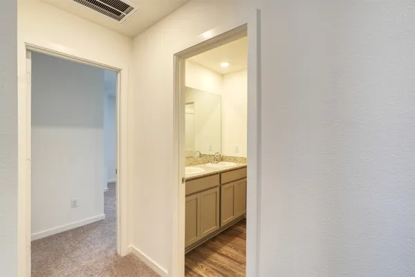 a view of a kitchen from a corridor