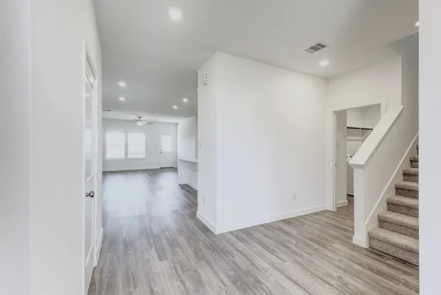 a view of a room with wooden floor and staircase