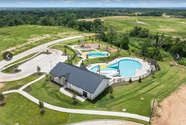 a view of a swimming pool with a yard