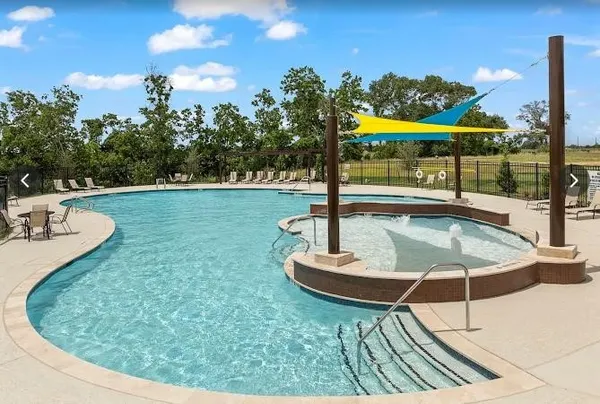 swimming pool view with a garden space