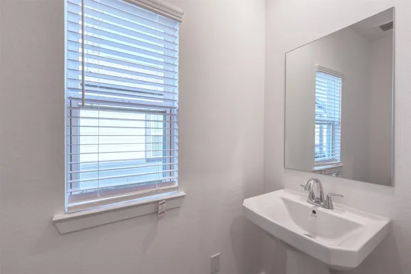 a bathroom with a sink a mirror and a window