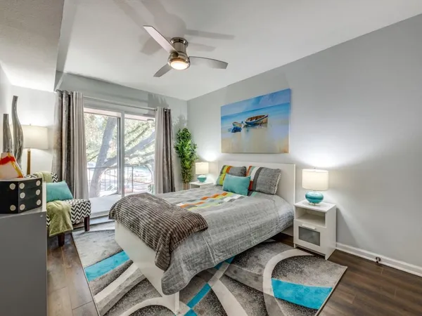 a bedroom with a bed window and a table