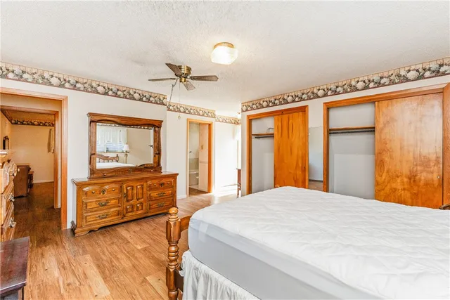 a spacious bedroom with a large bed and a dresser