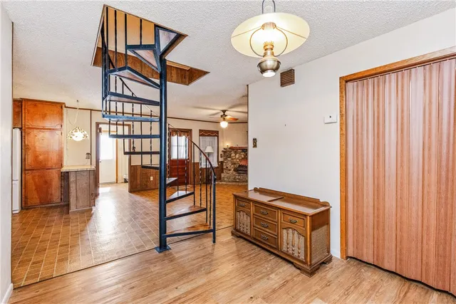 a view of a hallway with wooden floor and entryway