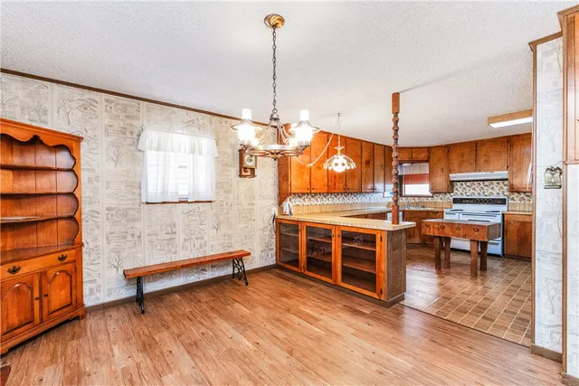 a view of an empty room with furniture wooden floor and window