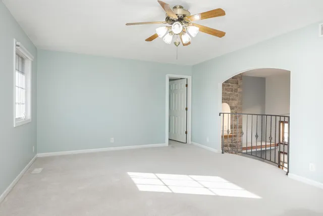 a view of entryway and hall with a chandelier fan