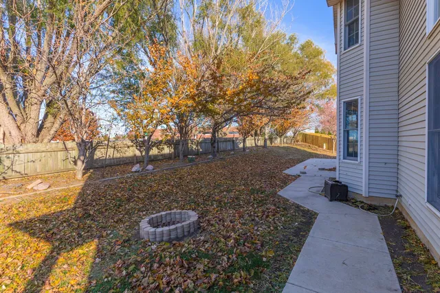 a view of a backyard with large trees