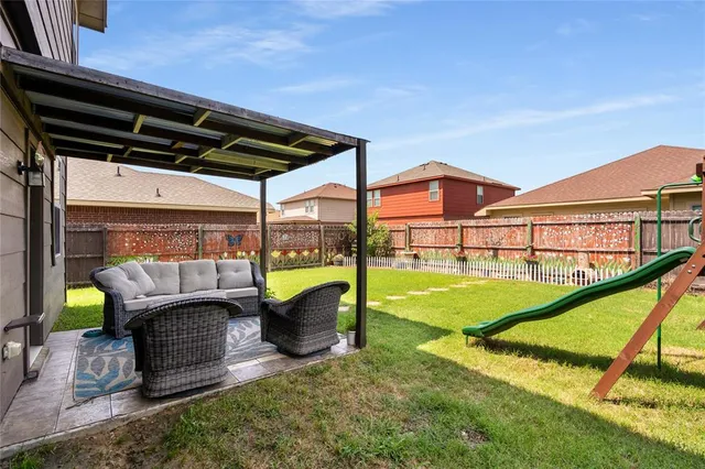 an aerial view of a house with swimming pool garden and patio