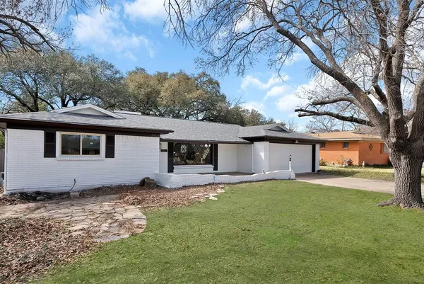 a house that has a tree in front of the house