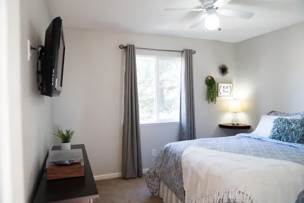 a bedroom with a bed and a window